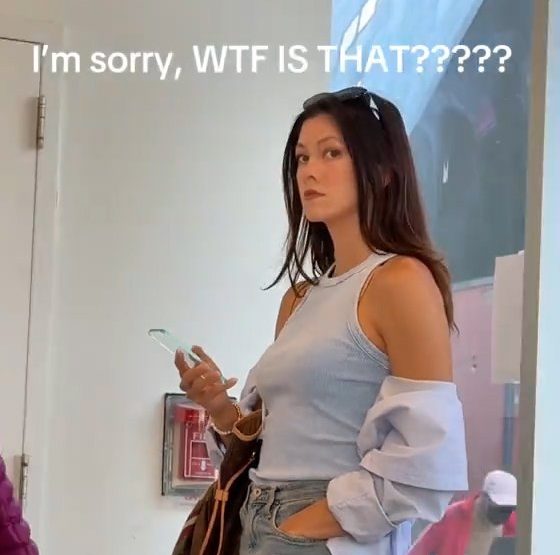 Woman holding a potential Nokia clear phone in public